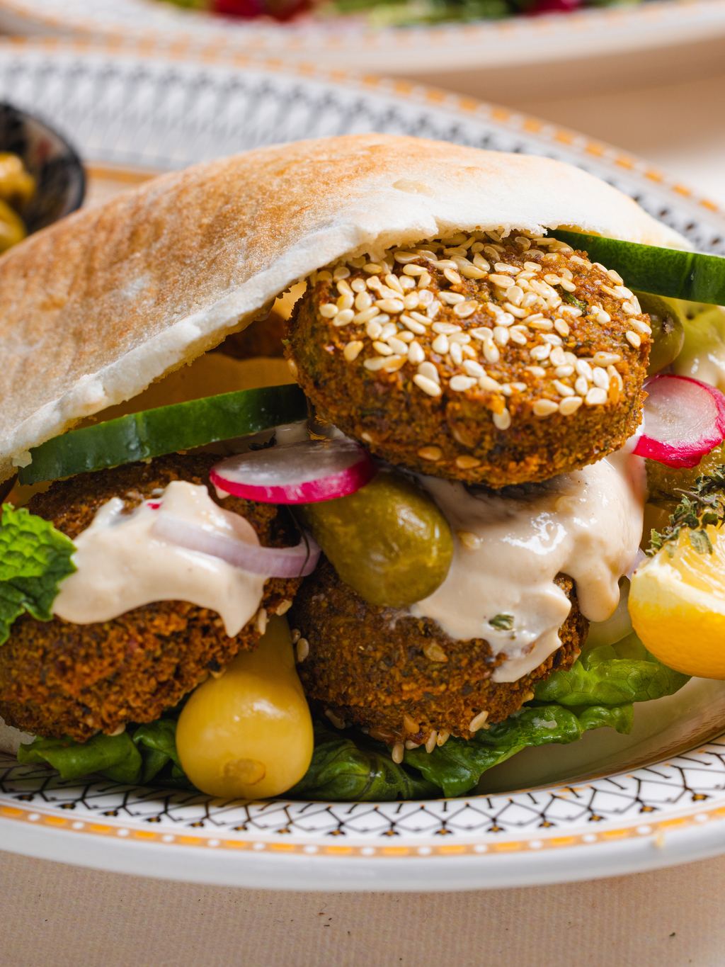 The falafel pita pocket with pickles, radish and spicy mango tahini
