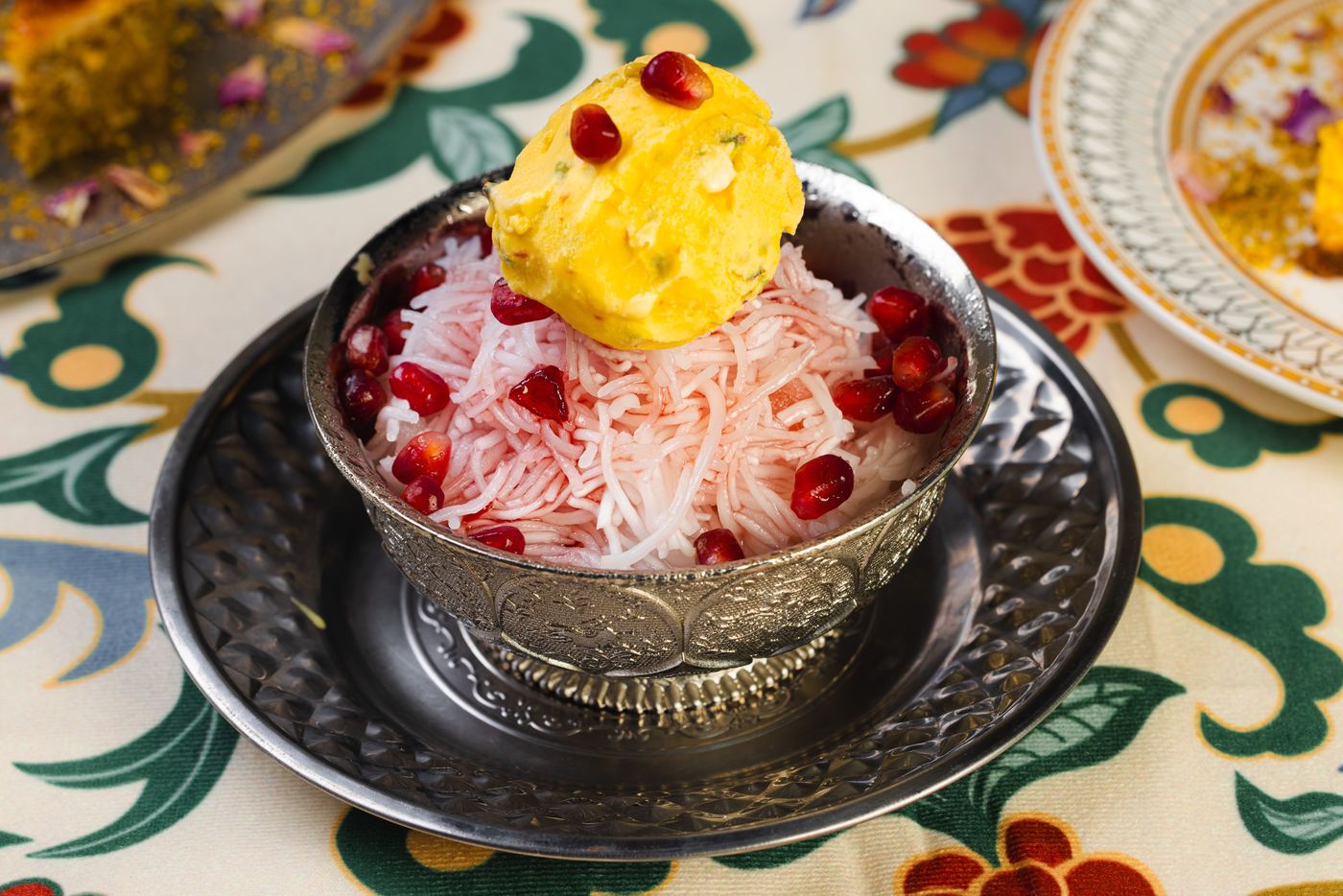 Original faloodeh Shirazi with saffron ice cream and pomegranate, served in an engraved silver bowl