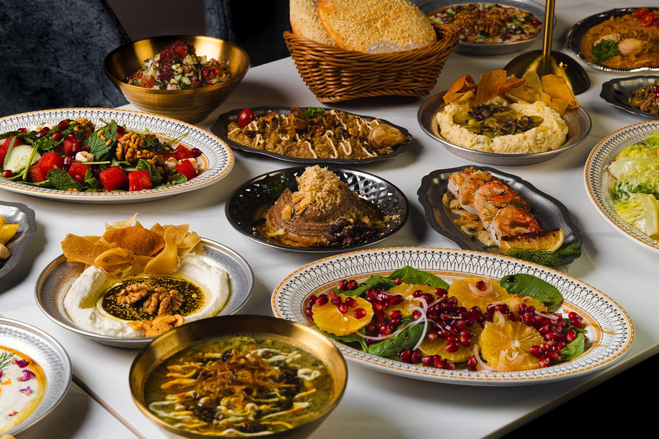 The Shirazi table laid: fresh sesame bread, dips, salads and soups across the marble