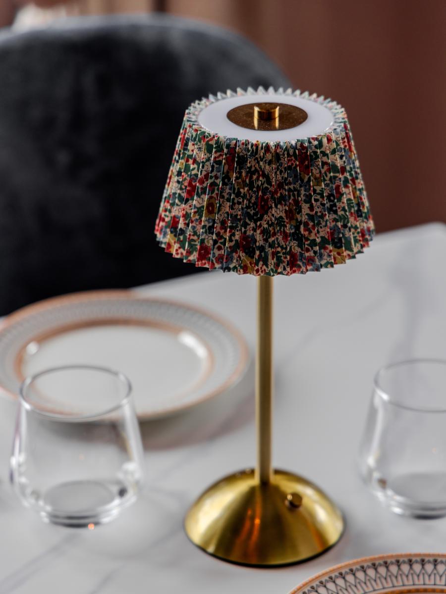 A beaded table lamp glowing over the marble