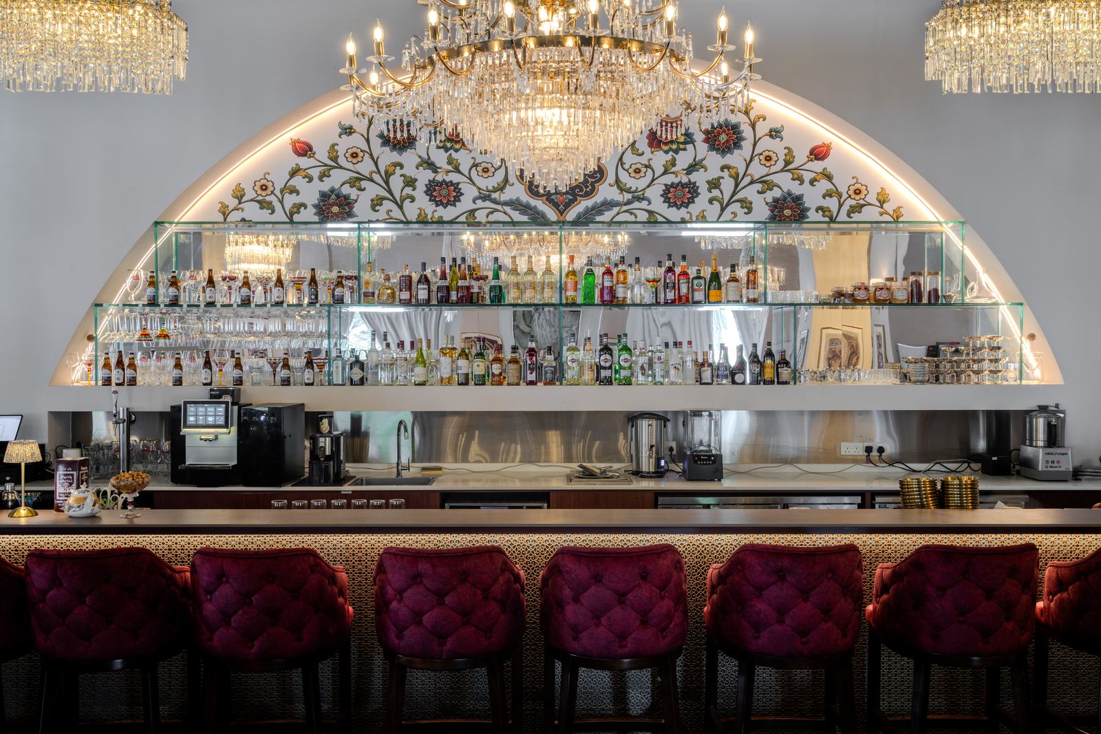 The bar at Shirazi: an illuminated floral arch, crystal chandeliers and burgundy velvet stools