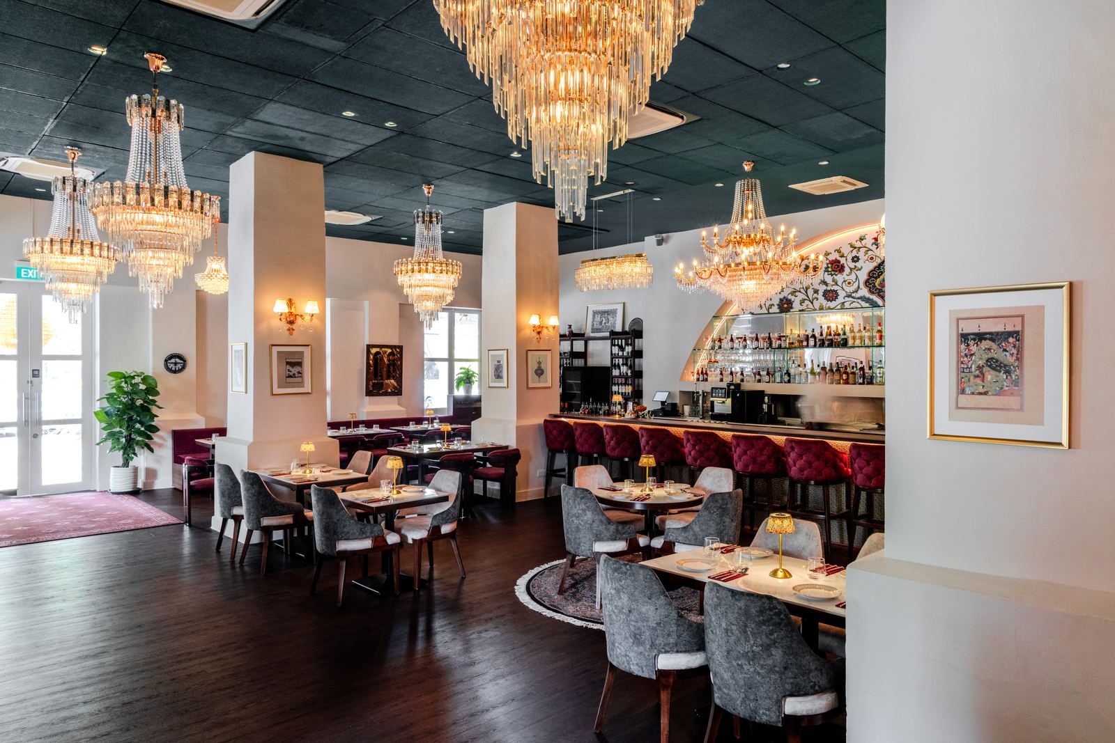 The dining room at Shirazi: chandeliers, marble tables and the arched bar